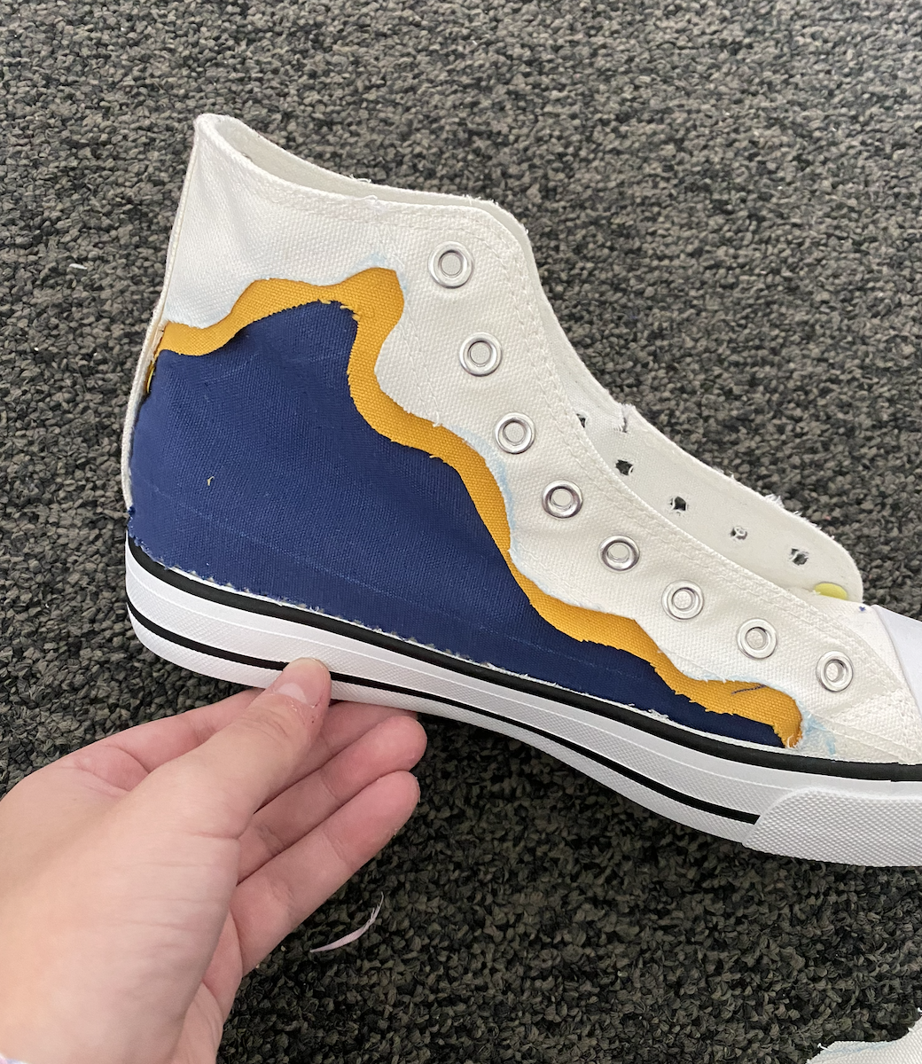 White high-top sneaker with a blue and yellow interchangeable panel