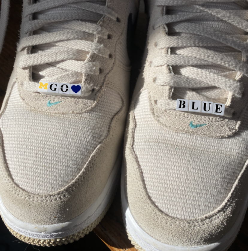 Beads spelling GO BLUE on turf shoes