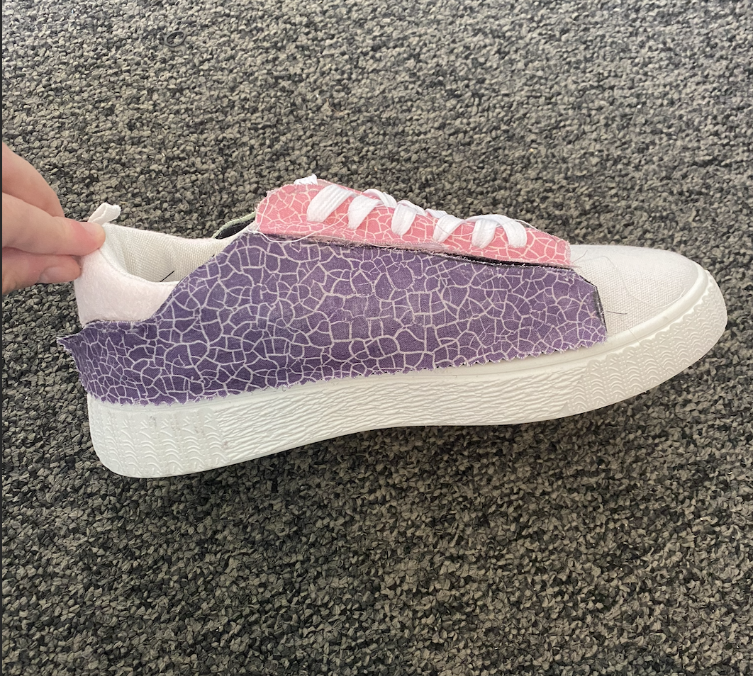Sneaker with a purple crackle-pattern velcro panel attached
